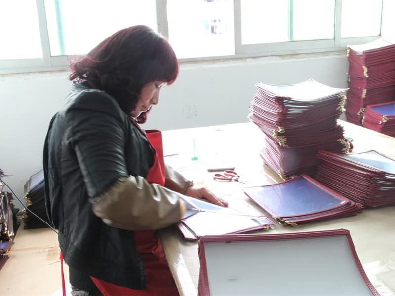 Cleaning menu covers during production quality checks