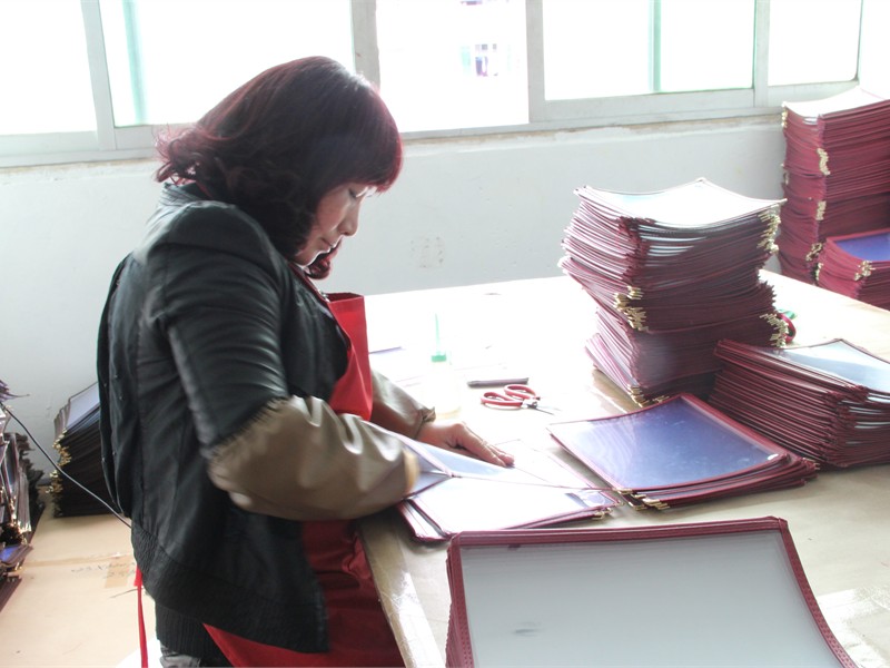 Cleaning menu covers during production quality checks