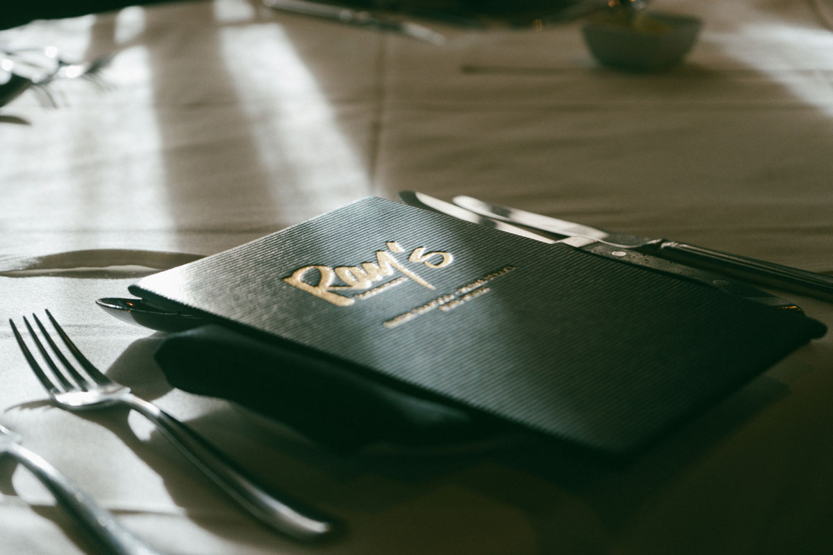 Custom menu cover displayed on a restaurant table